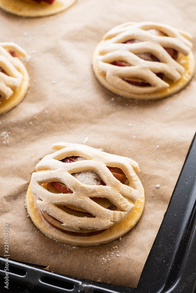 Cooking process of galetta, biscuit with apples on paper background. Apple pie with cinnamon. Cooking process of galetta, biscuit with apples on paper background. Apple pie with cinnamon.