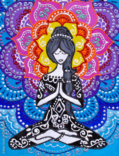 Painting, the girl sits in a lotus position, engaged in yoga, behind her bright mandala, bright colors.