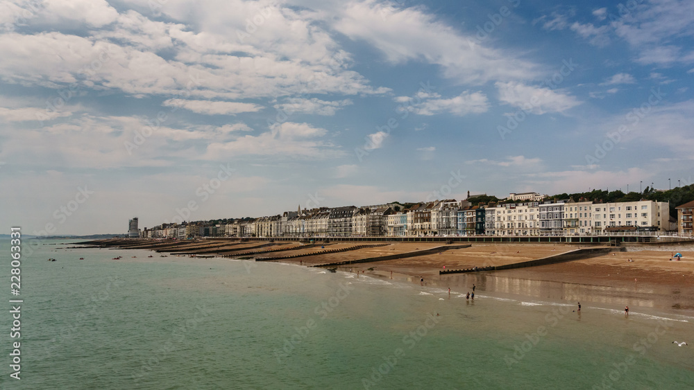 Hastings coastline with its beach on a sunny summer day - photo shot from the pier