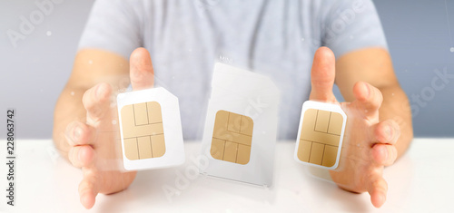 Businessman holding Different size of a smartphone sim card 3d rendering photo