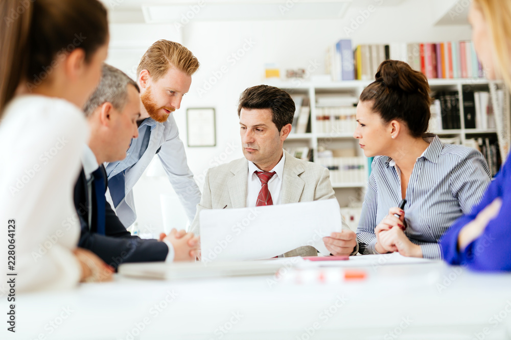Group of business people working as team in office Group of business people working as team in office