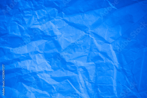 Crumpled blue paper background.