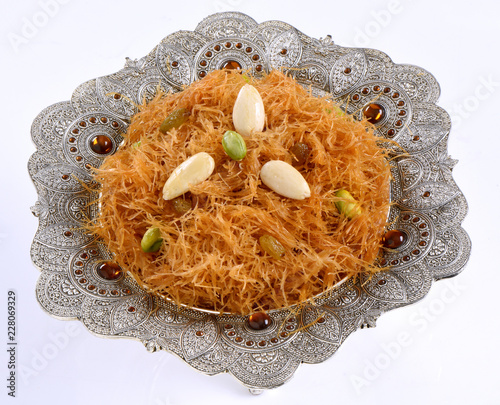 Vermicelli / Sawaiyan, A thin golden spaghetti type pasta sweet dish serve with condense milk and in sugar syrup. photo