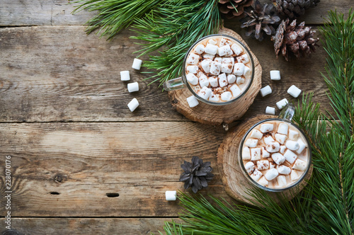 Cocoa with marshmallows in glass mugs on a wooden background