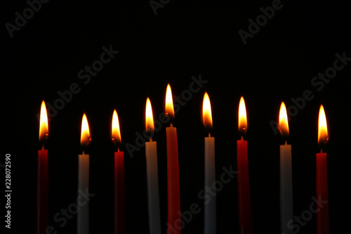 Low key Image of jewish holiday Hanukkah background with menorah (traditional candelabra) and burning candles.