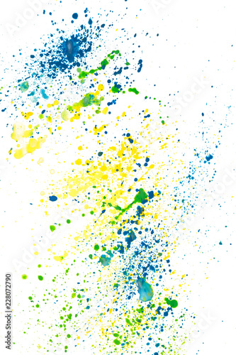 Watercolor paint sprinkles splatter of green  blue and yellow paint on white paper