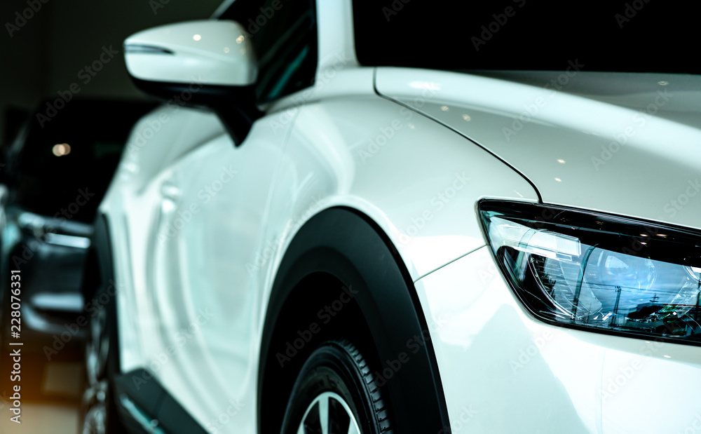 New luxury white car parked in modern showroom for sale. Car dealership office. Car retail shop. Electric or hybrid car technology and business concept. Automobile rental concept. Automotive industry. New luxury white car parked in modern showroom for sale. Car dealership office. Car retail shop. Electric or hybrid car technology and business concept. Automobile rental concept. Automotive industry.