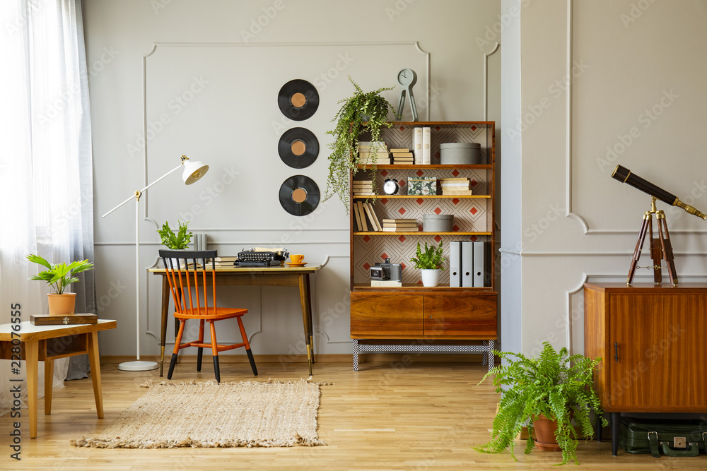 Vinyl records decorations on a gray wall with molding and wooden furniture  in a retro home office interior for a writer. Real photo. Stock-Foto |  Adobe Stock