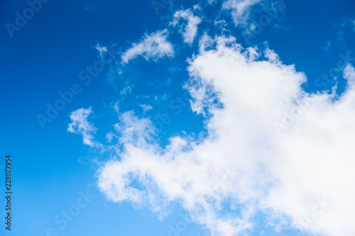 The blue sky with moving white clouds. The sky is a beautiful color shade suitable for use as a background image.