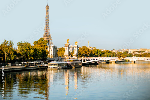 Alexandre bridge and Eiffel tower on Seine river during the morning light in Paris