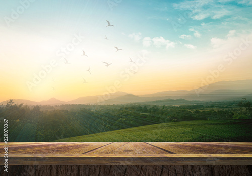 World environment day concept: Wooden table and mountain sunrise background