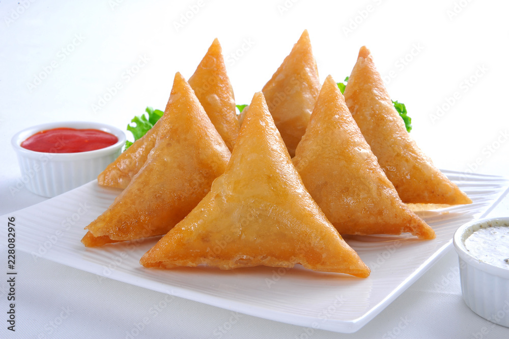 Samosa, Sambusa, Samboksa with a   savory filling of chicken, mince, potato & vegetables