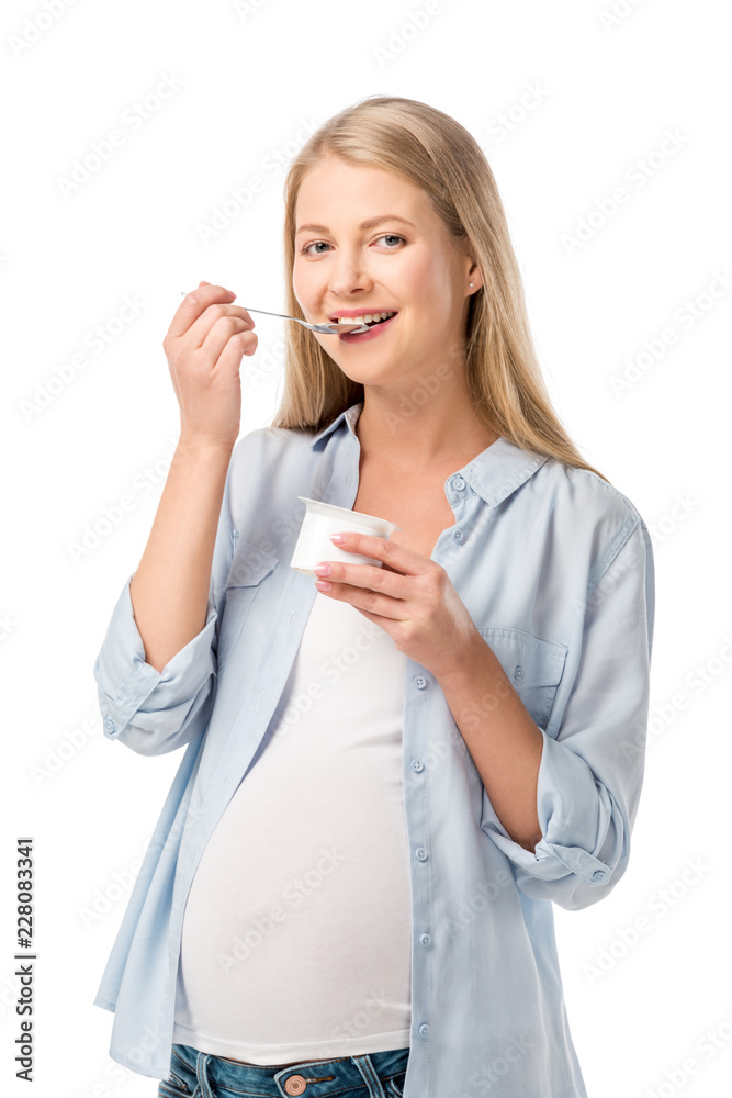 smiling pregnant woman eating yogurt with spoon isolated on white smiling pregnant woman eating yogurt with spoon isolated on white