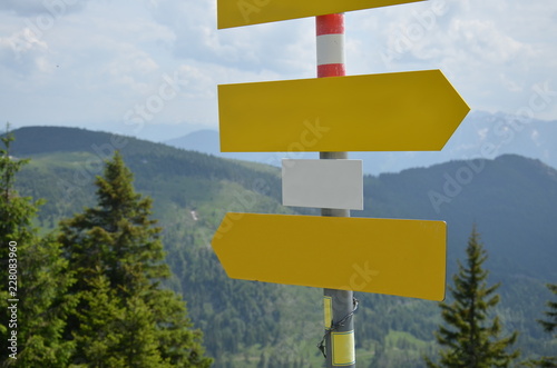 Empty signs with mountain scenery in the background