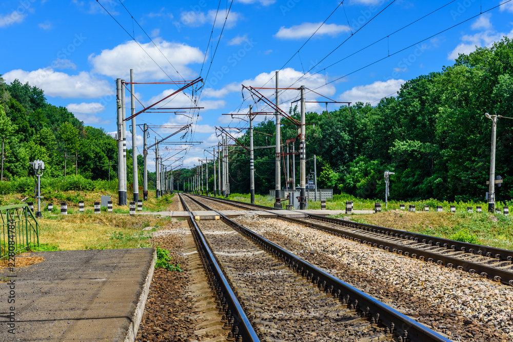 View on a railroad track and white clouds in blue sky