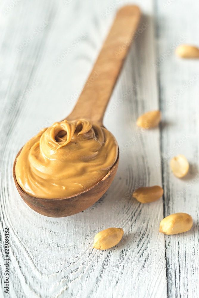Wooden spoon of peanut butter Wooden spoon of peanut butter