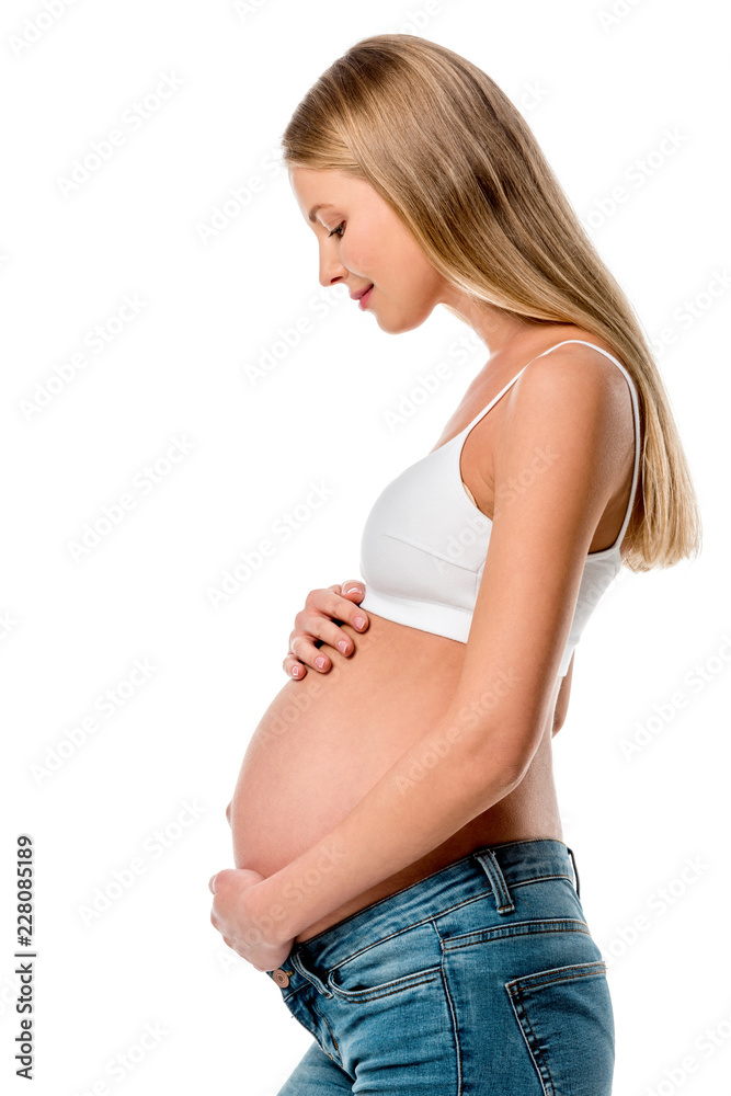 side view of attractive pregnant woman touching her belly isolated on white side view of attractive pregnant woman touching her belly isolated on white