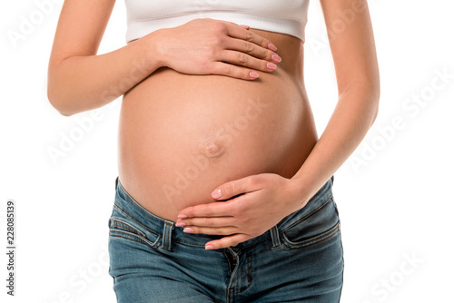 cropped view of pregnant woman touching her belly isolated on white © LIGHTFIELD STUDIOS