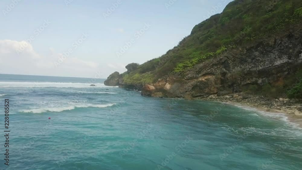 Aerial shot of ocean waves crashing coastline cliff Aerial shot of ocean waves crashing coastline cliff
