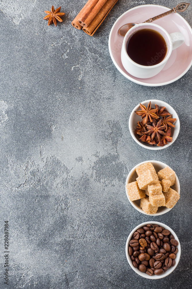 Cup of coffee, brown sugar and cinnamon with anise on concrete background. Copy space Cup of coffee, brown sugar and cinnamon with anise on concrete background. Copy space