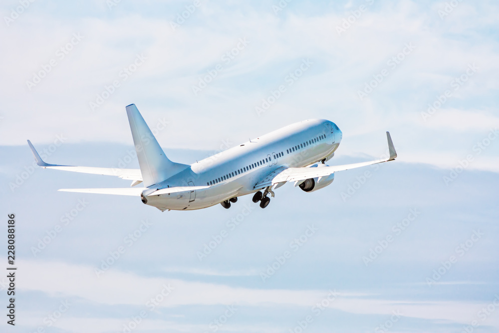 Obraz premium White passenger jet plane in the air on take-off