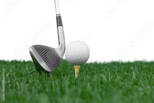 Golf Ball on Tee and Club on Golf Course