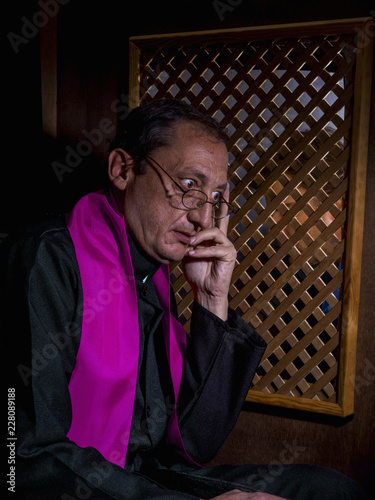Portrait of a priest in his confessional