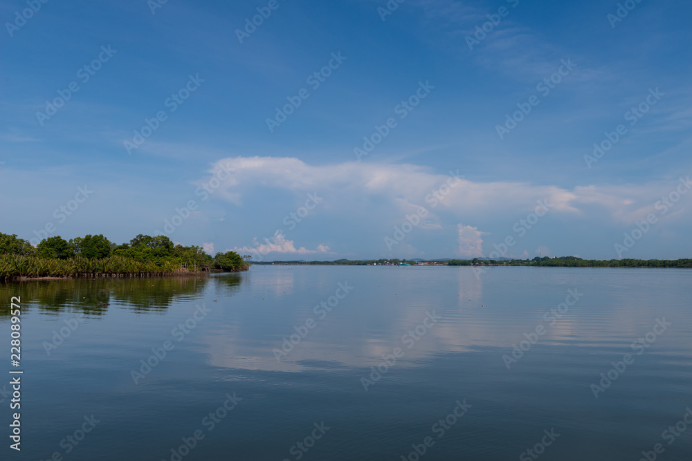 Fototapeta premium clouds blue sky above ocean and sea waves