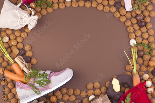 Dutch holiday Sinterklaas background with pepernoten.Traditional sweets and gifts for children for the holiday. Free space for text. Top view. Copy space. Boot, carrot and letter with desires. photo