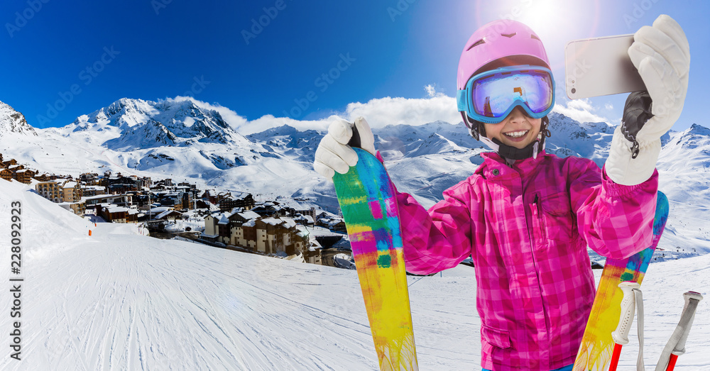 Teenager taking a selfie, girl taking a self portrait with mobile phone, sport skiing having fun on winter vacation. - obrazy, fototapety, plakaty 