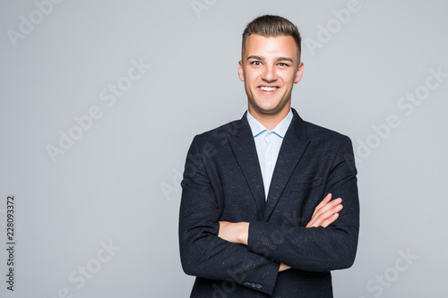 Portrait of businessman with crossed hands, isolated on white background. Concept of leadership and success © dianagrytsku