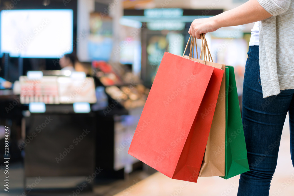 Shopping woman holding bags isolated on white background, consumerism, sale and people concept
