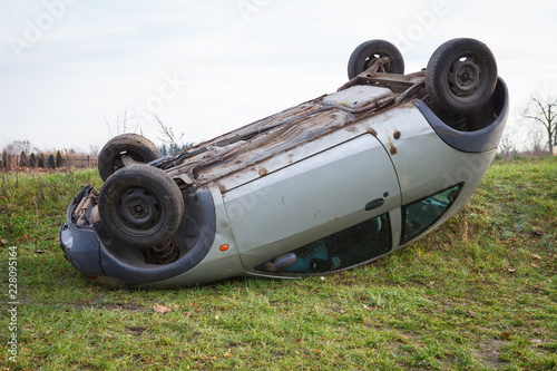 Traffic accident, car after rollover lie on the roof photo