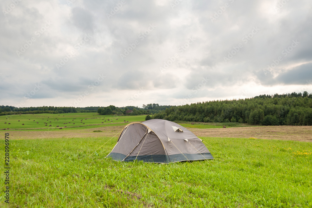 Tent in countryside, quiet summer holiday.