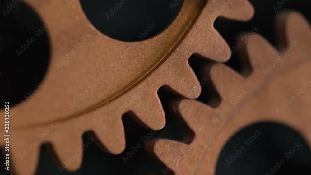close up on clock's wheels running: time passing, symbol