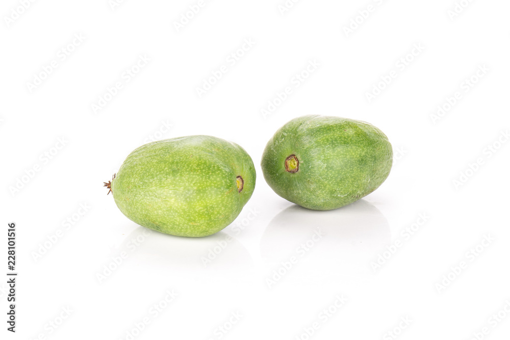 Group of two whole bright fresh green mini baby kiwi fruit isolated on white background Group of two whole bright fresh green mini baby kiwi fruit isolated on white background
