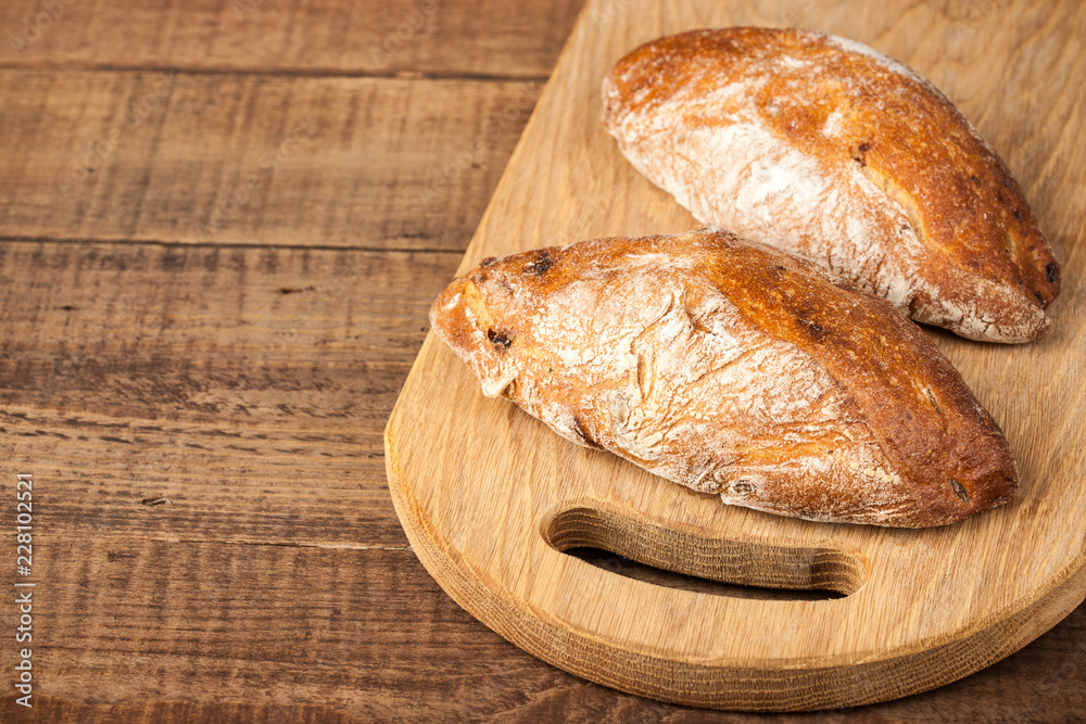 Ciabatta buns on wooden table Ciabatta buns on wooden table