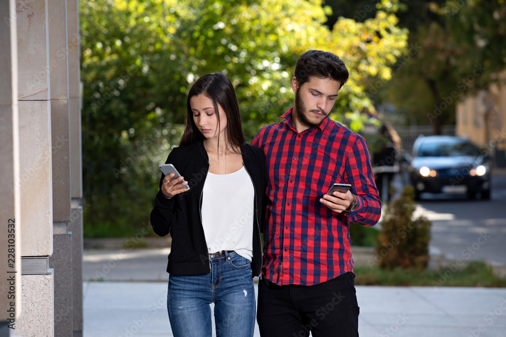 couple together and separately, using smartphones separately

