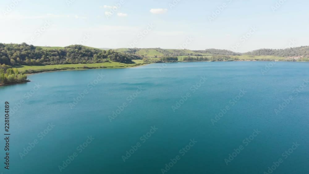 Drone flying over lake and beach. Martignano lake,Rome, Italy