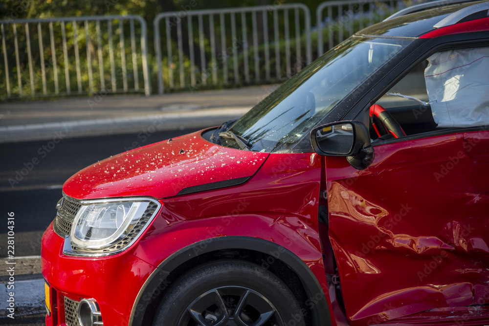 Red car crashed all over the driver side Red car crashed all over the driver side
