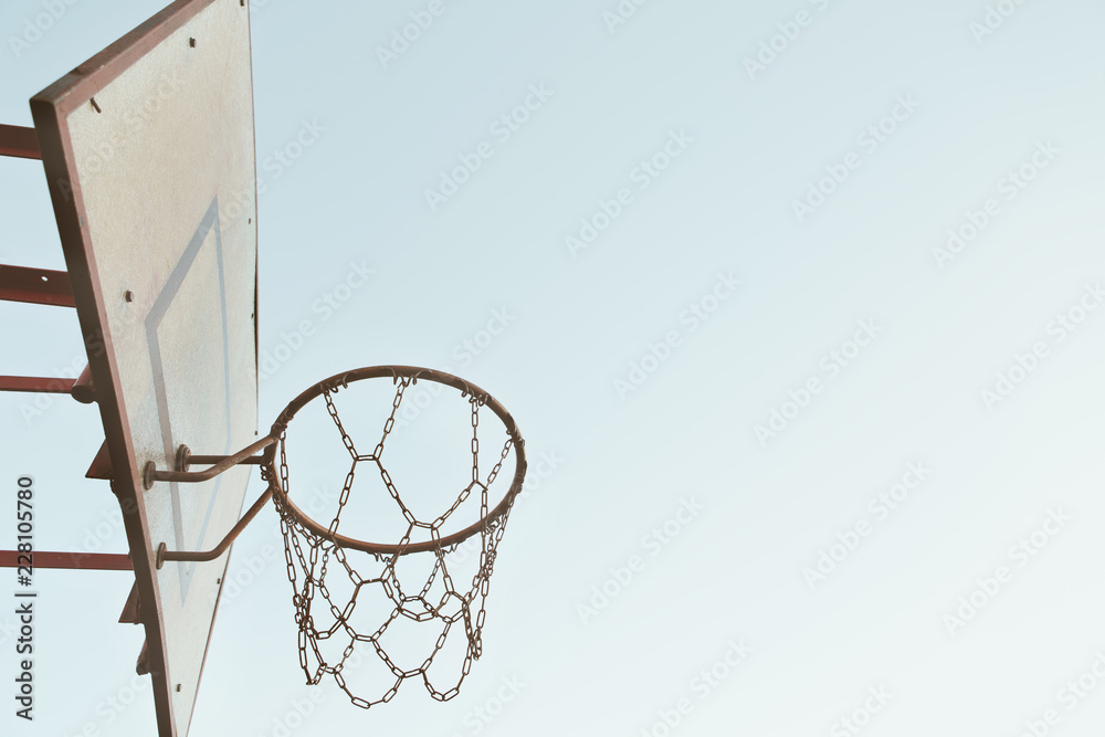 Old rusty chain basketball basket grunge with cloudless sky background