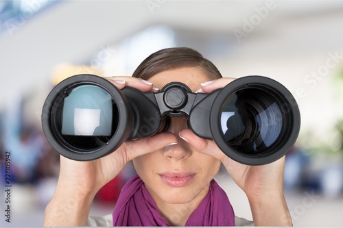 Woman looking through binoculars