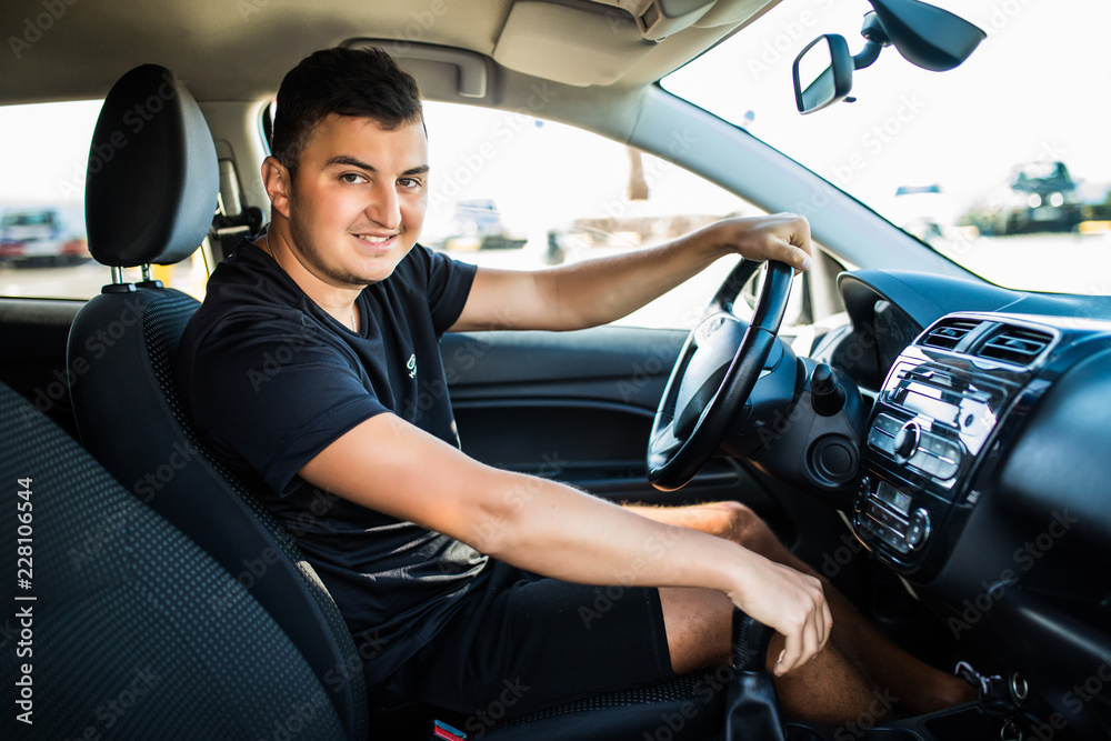 Handsome young smile man having summer trip on a car. Handsome young smile man having summer trip on a car.