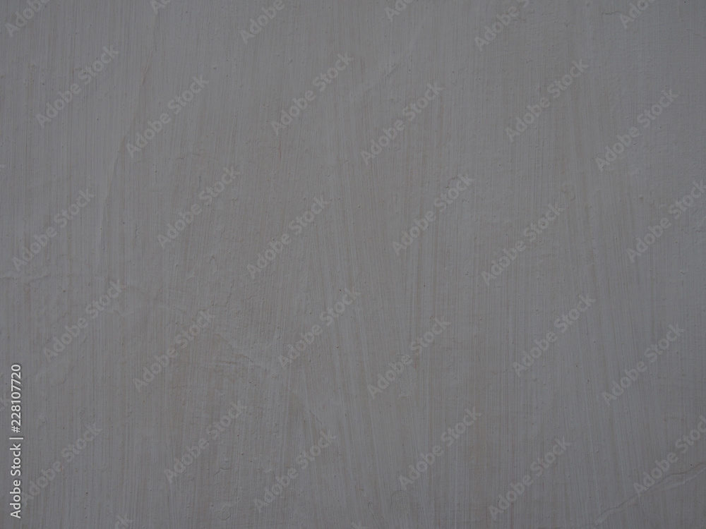 Fototapeta premium old light grey painted wall surface with textured brush marks and faint cracks full frame background