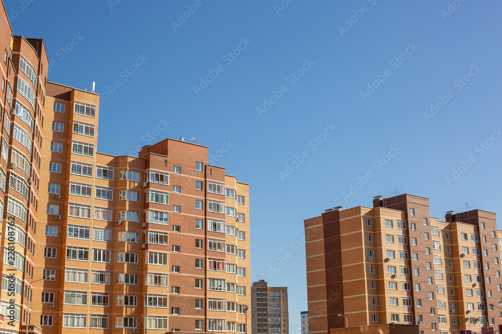 Residential multi-storey building against the blue sky
