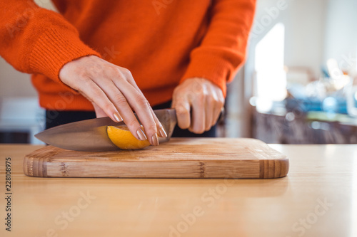 Woman cutting orange