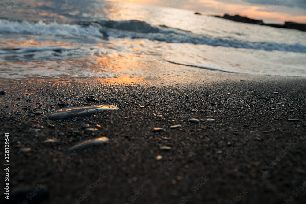 sunset at sea, bottom view, sand at sunset, waves with foam sunset at sea, bottom view, sand at sunset, waves with foam