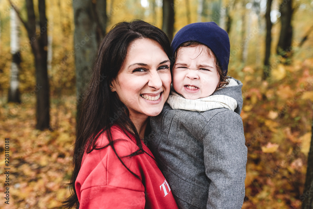 happy mather and child in autumn park happy mather and child in autumn park