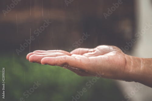 Closeup of woman hand under rain