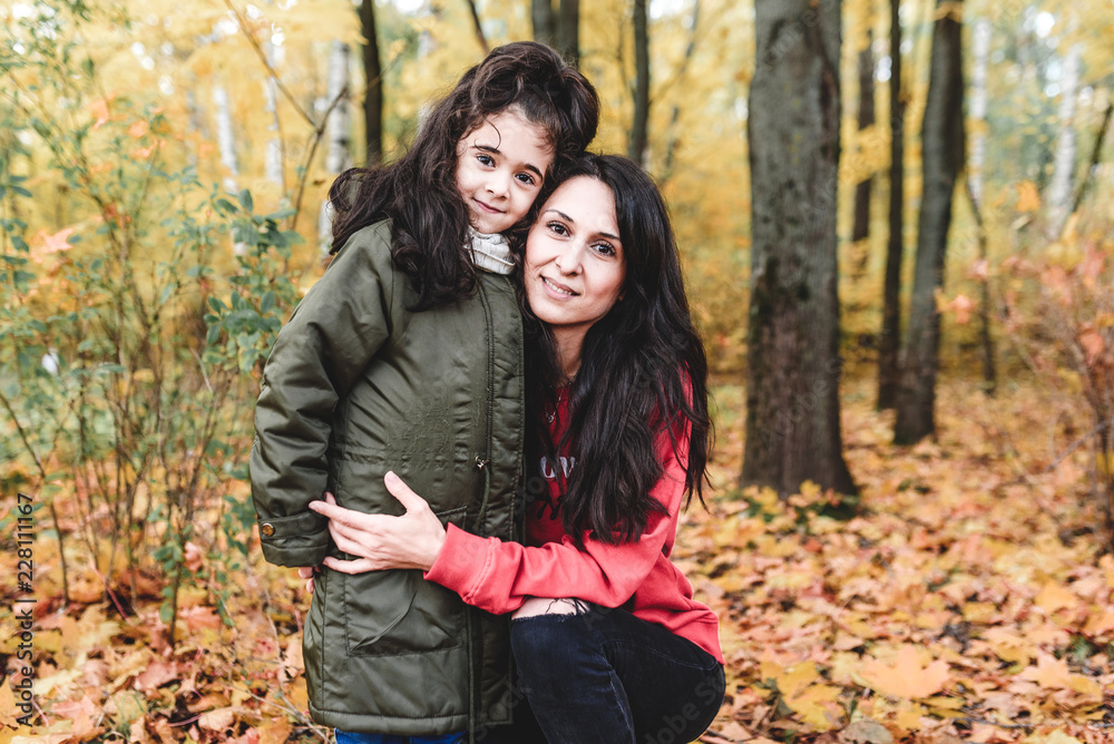 mather and doughter in autumn city park mather and doughter in autumn city park